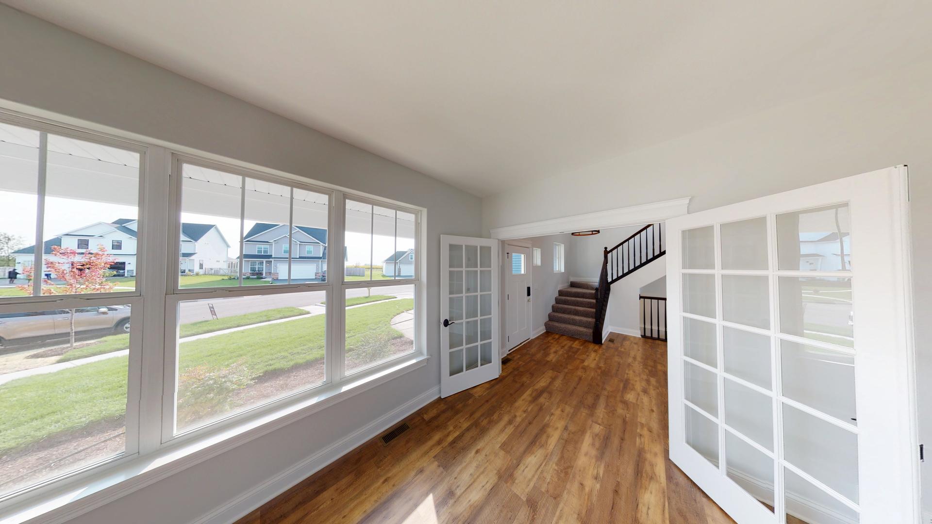 118 Cache Isle Circle Channahon, IL 60410 - Photo 17 of 32 a view of wooden floor and windows in a room