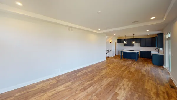 a view of a kitchen with a sink and a refrigerator