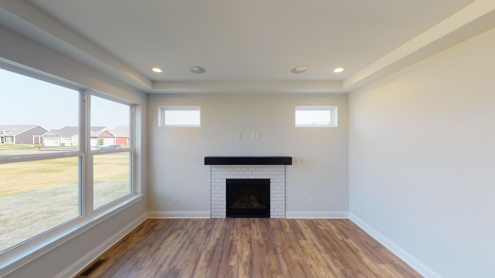 118 Cache Isle Circle Channahon, IL 60410 - Photo 8 of 32 a view of an empty room with a window and wooden floor