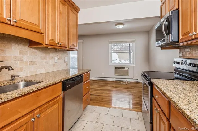 a kitchen with granite countertop a sink stove and cabinets