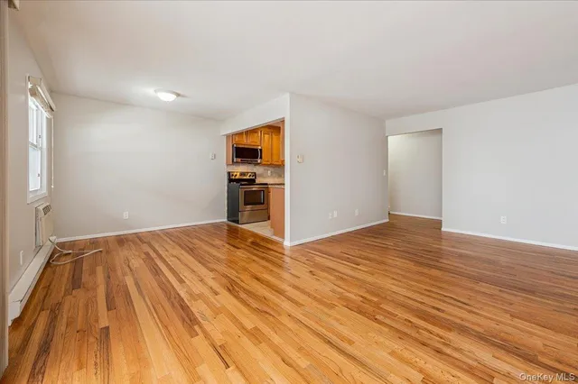 a view of empty room with wooden floor