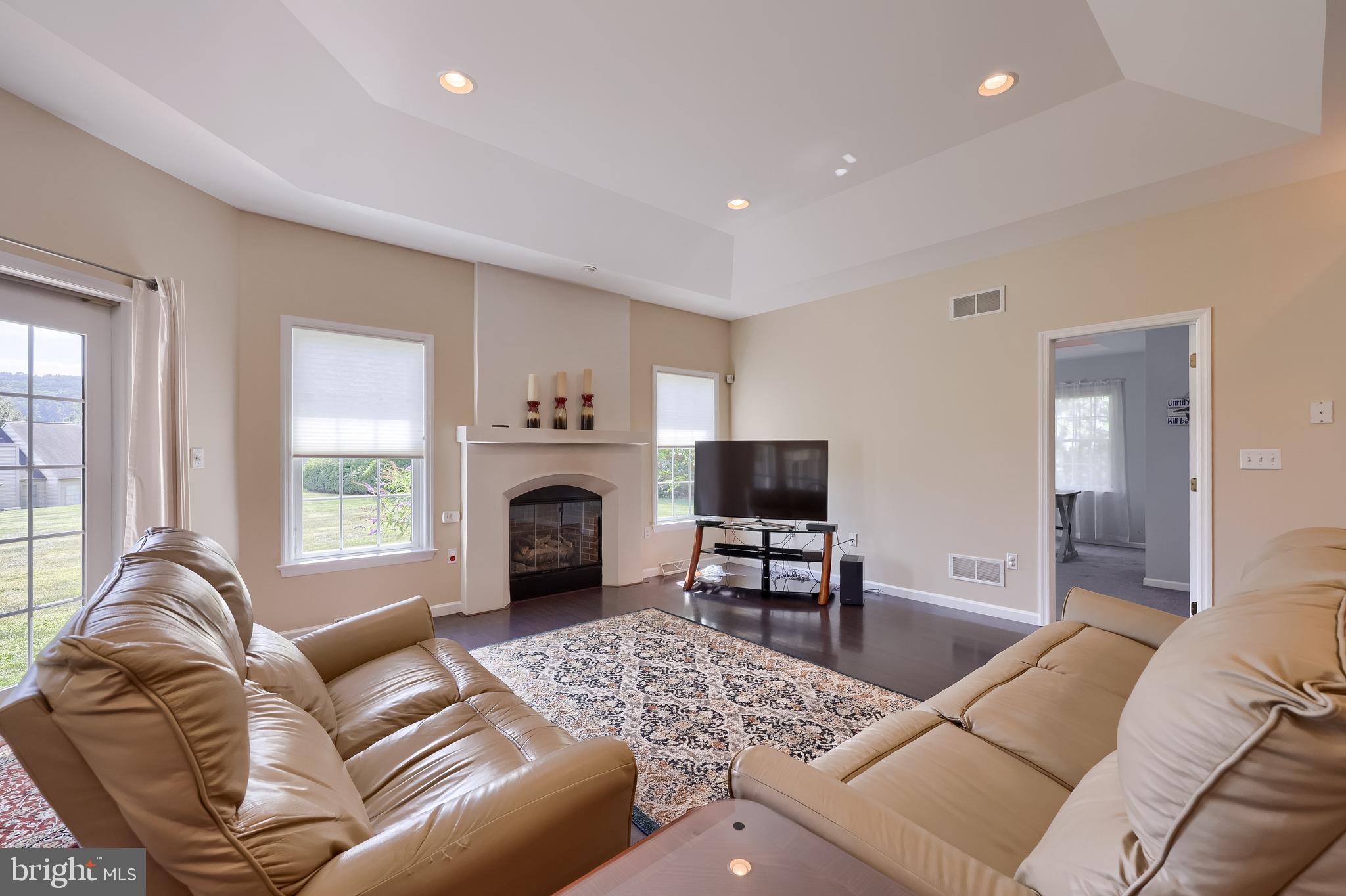 890 Fishburn Road Hershey, PA 17033 - Photo 21 of 103 a living room with furniture a fireplace and a flat screen tv
