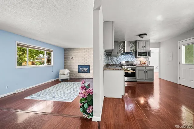 a kitchen view with kitchen island stainless steel appliances sink stove and refrigerator