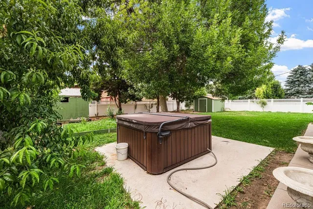 a view of a backyard with wooden fence