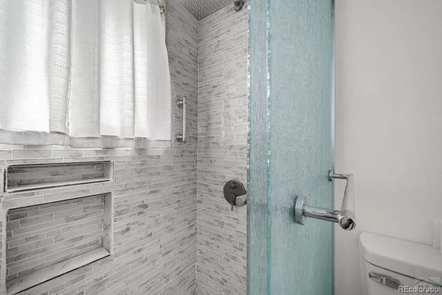 a bathroom with a shower and a sink