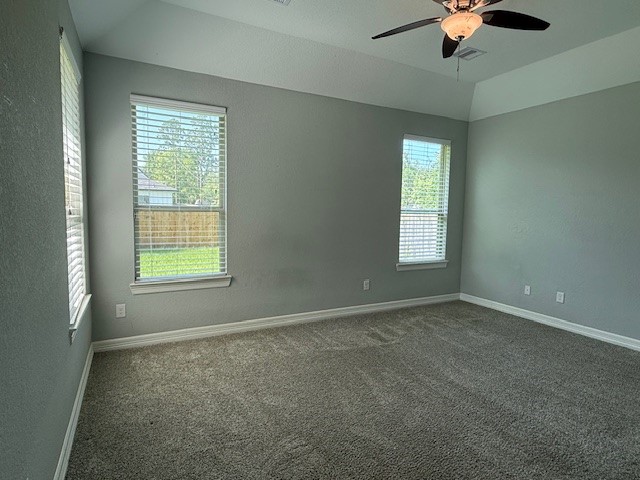 1541 Primrose Street Conroe, TX 77385 - Photo 11 of 25 en empty room with windows and chandelier fan