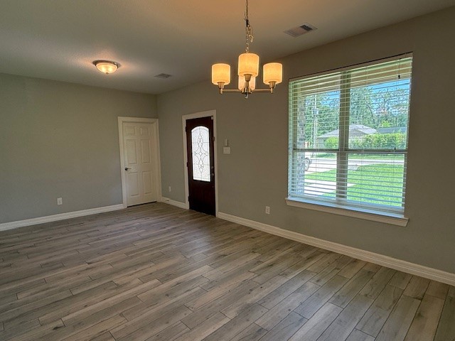 1541 Primrose Street Conroe, TX 77385 - Photo 4 of 25 an empty room with wooden floor and windows