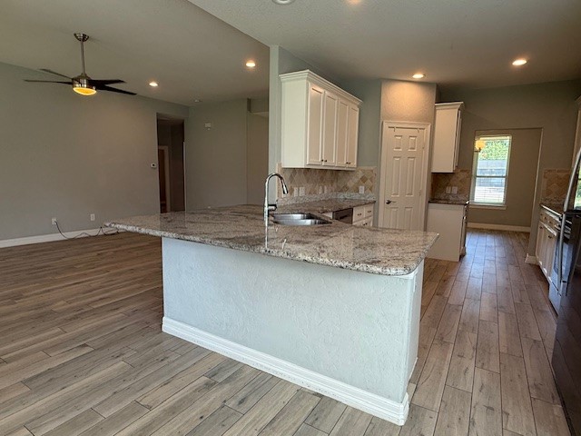 1541 Primrose Street Conroe, TX 77385 - Photo 8 of 25 a view of a kitchen with granite countertop wooden floor stainless steel appliances and cabinets