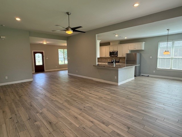 1541 Primrose Street Conroe, TX 77385 - Photo 25 of 25 a view of a kitchen with wooden floor and a fireplace