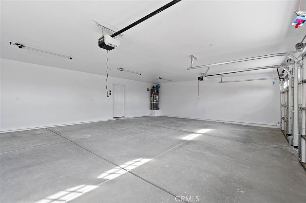 14685 Apple Valley Road Apple Valley, CA 92307 - Photo 15 of 29 a view of a room with stairs and a chandelier fan