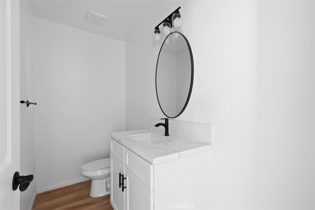 14685 Apple Valley Road Apple Valley, CA 92307 - Photo 19 of 29 a bathroom with a sink a toilet and a mirror