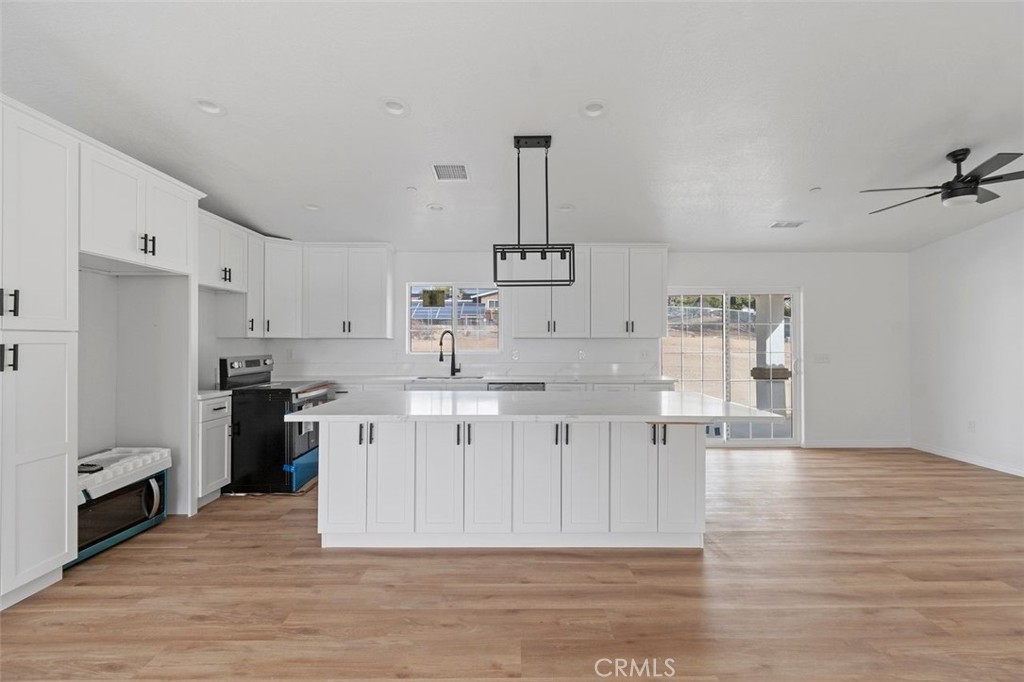 14685 Apple Valley Road Apple Valley, CA 92307 - Photo 27 of 29 a kitchen with granite countertop a sink stainless steel appliances and cabinets