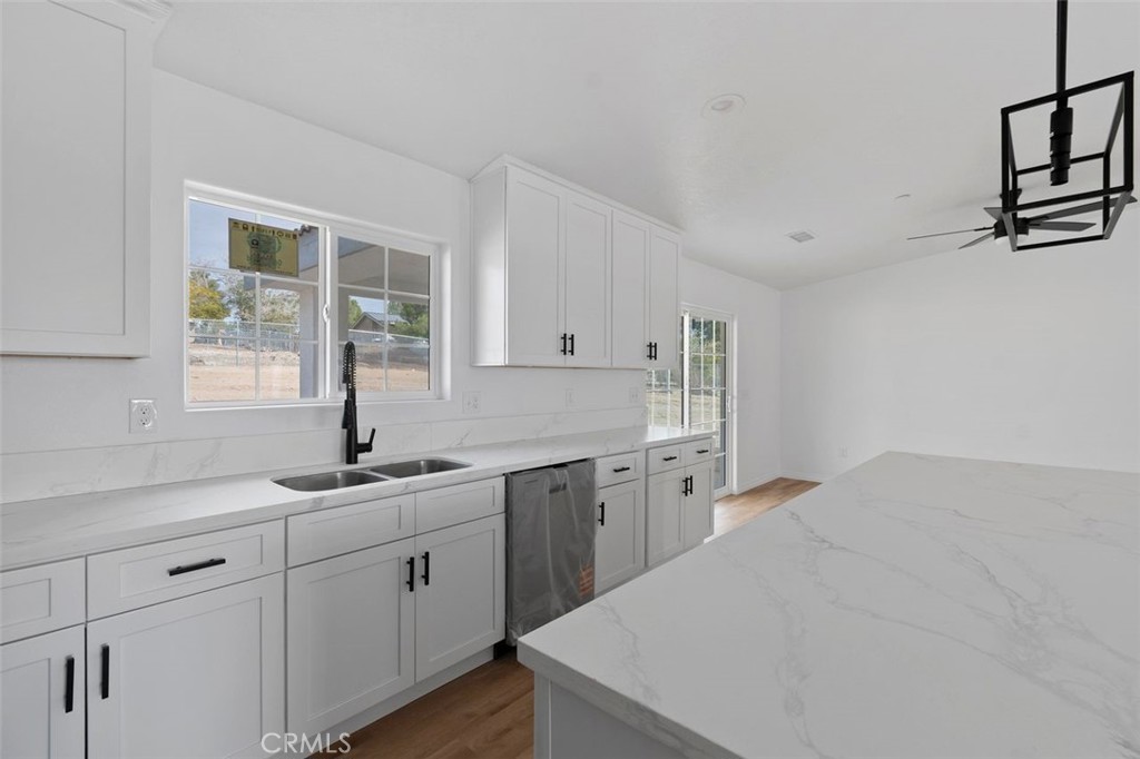 14685 Apple Valley Road Apple Valley, CA 92307 - Photo 29 of 29 a kitchen with sink cabinets and window