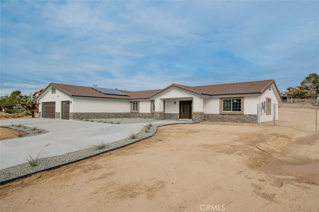 14685 Apple Valley Road Apple Valley, CA 92307 - Photo 3 of 29 a front view of a house with a yard