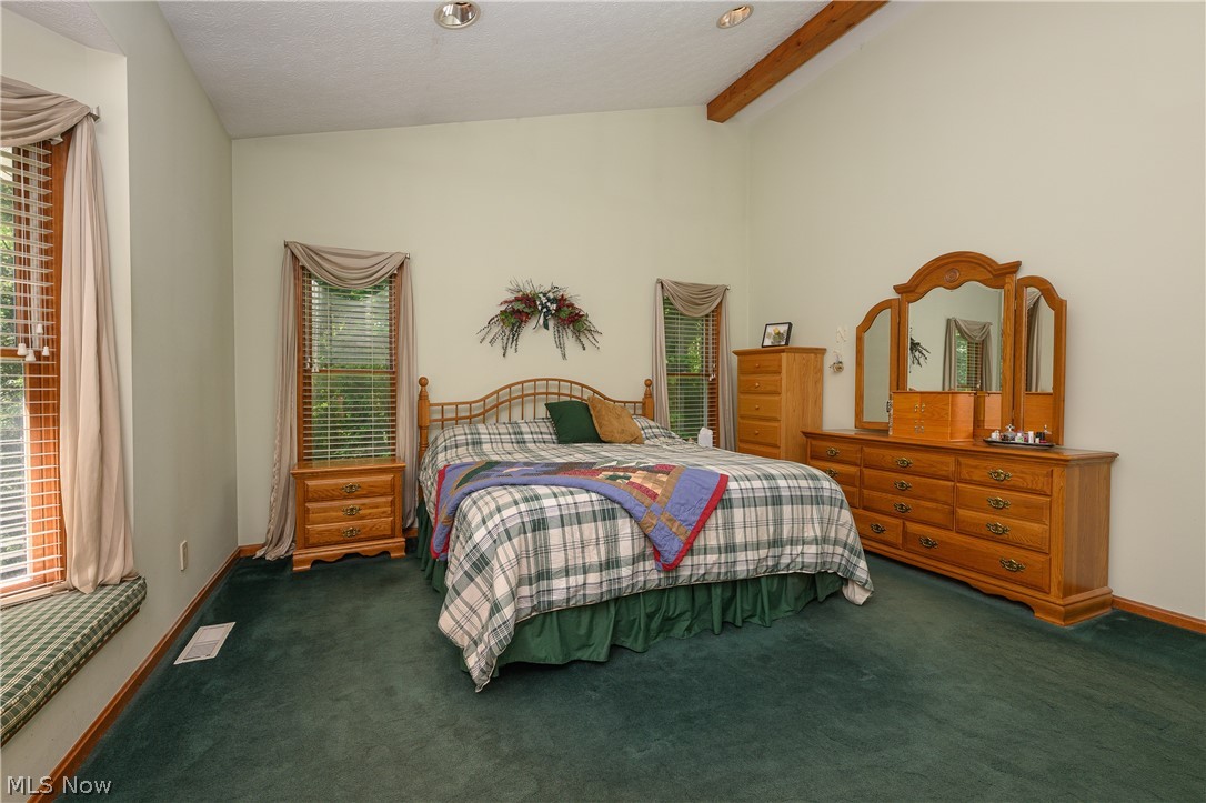 8745 Broadview Road Broadview Heights, OH 44147 - Photo 11 of 49 Spacious bedroom featuring vaulted ceilings with exposed wood beams, recessed lighting, and soft green wall tones
