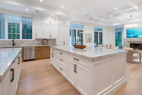 a kitchen with stainless steel appliances granite countertop a sink and a stove