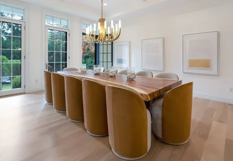 a dining hall with granite countertop a sink dishwasher a stove and a dining table with garden view