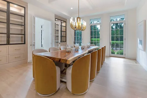 a room with stainless steel appliances kitchen island granite countertop furniture and a large window