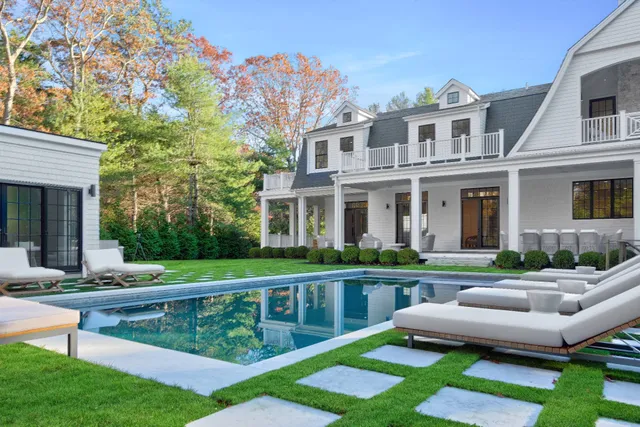 a front view of a house with a yard table and chairs