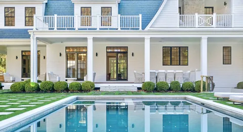 a view of a house with a swimming pool and a porch