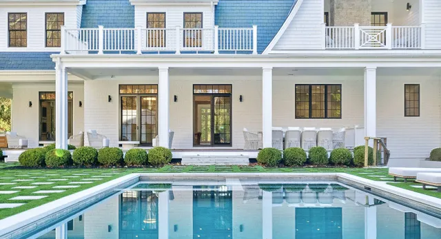a view of a house with a swimming pool and a porch