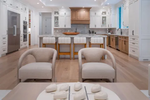 a living room with furniture and kitchen