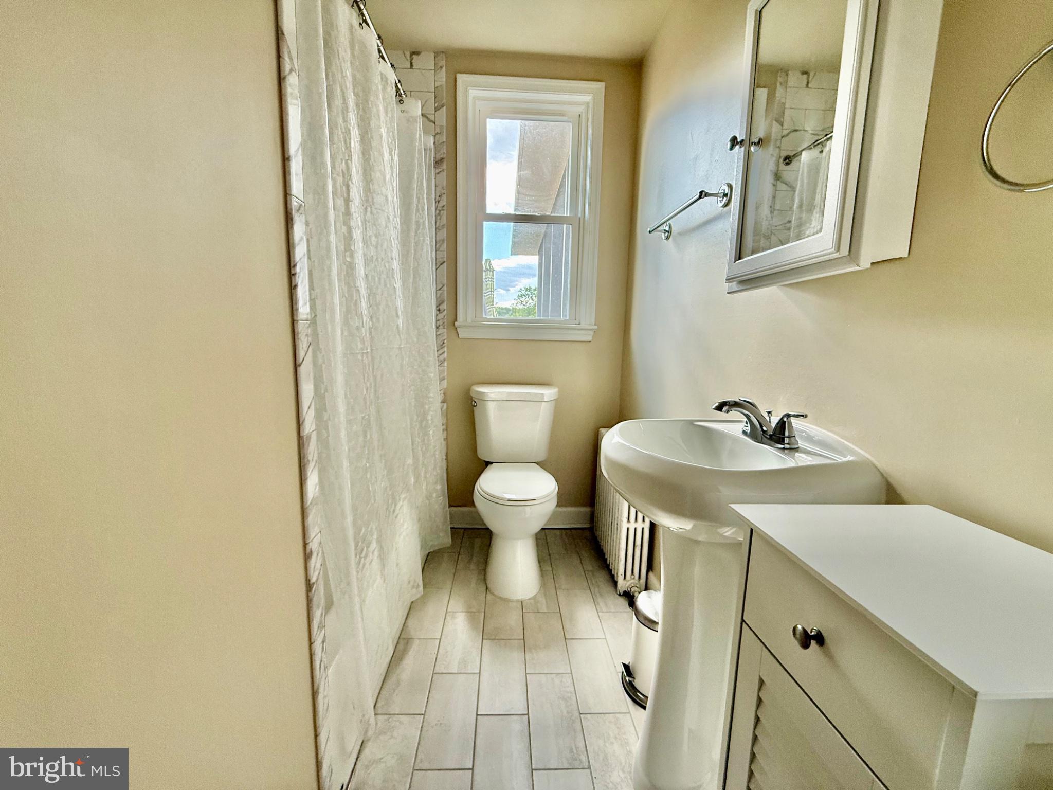 4014 32nd Street Mount Rainier, MD 20712 - Photo 8 of 33 a bathroom with a sink and mirror with toilet