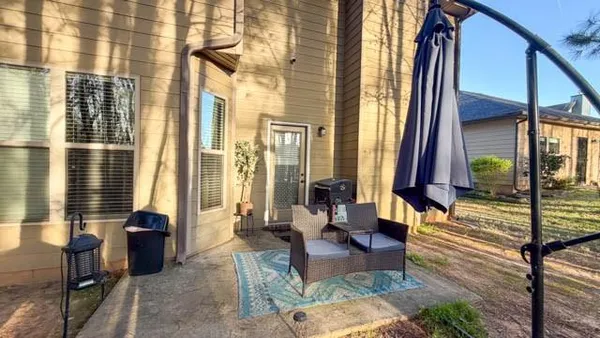 a living room with furniture and large windows
