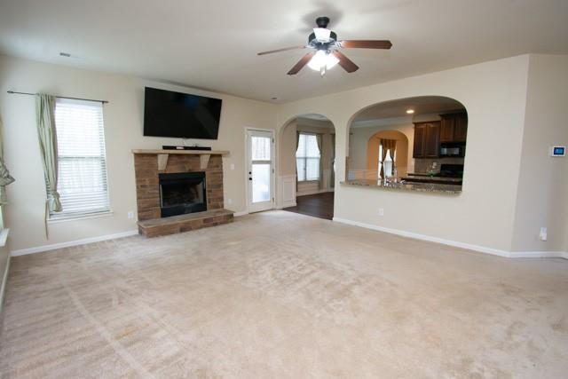 250 Sylvan Loop Fayetteville, GA 30214 - Photo 2 of 18 a view of a livingroom with a fireplace a ceiling fan and window