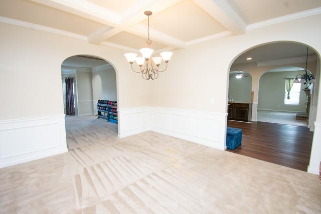 250 Sylvan Loop Fayetteville, GA 30214 - Photo 8 of 18 a view of a hallway with wooden floor and chandelier