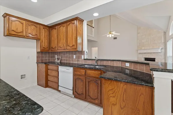 a kitchen with stainless steel appliances granite countertop a sink stove and cabinets