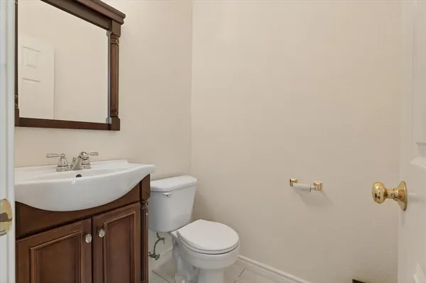 a bathroom with a sink toilet and mirror