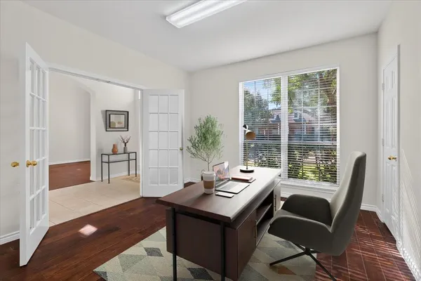 a view of a workspace with furniture and a window