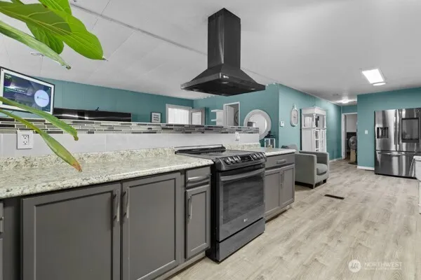 a large kitchen with granite countertop a stove and a sink