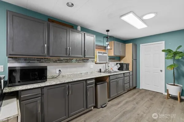 a kitchen with stainless steel appliances granite countertop a stove sink and cabinets