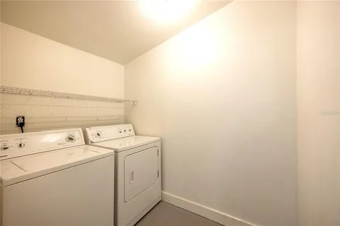 a view of storage and utility room with washer and dryer