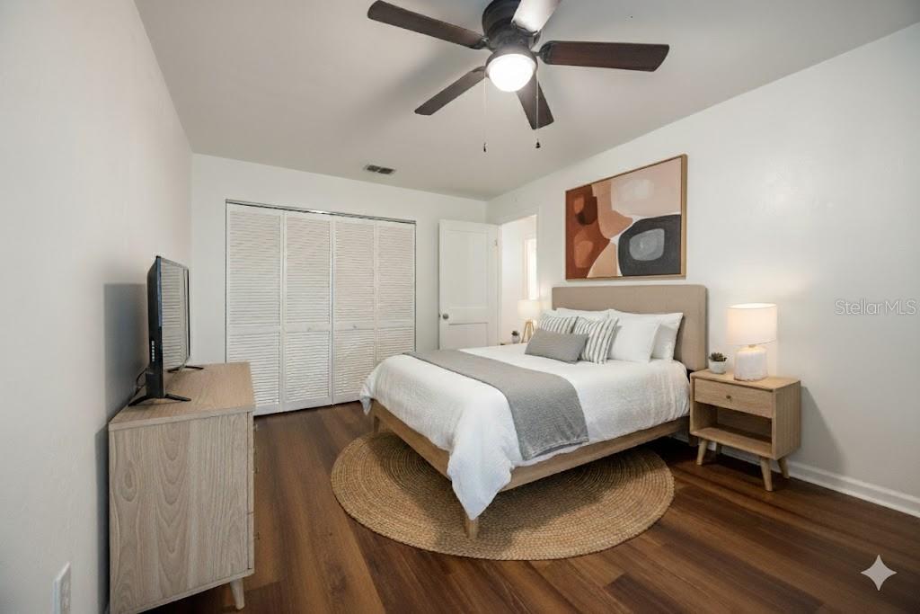 6708 Southwest 45th Avenue Gainesville, FL 32608 - Photo 27 of 40 a bedroom with a bed and a chandelier