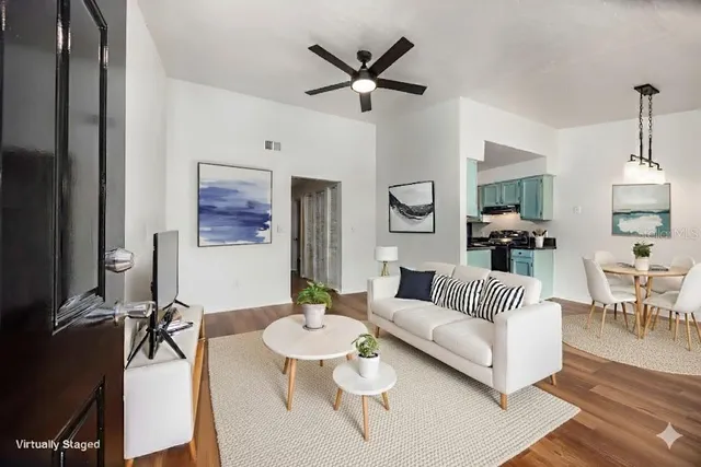 a living room with furniture and a chandelier
