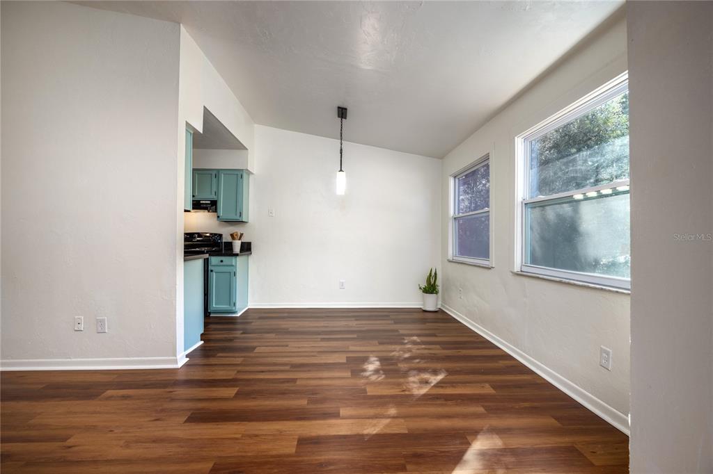 6708 Southwest 45th Avenue Gainesville, FL 32608 - Photo 6 of 40 a view of an empty room with window and wooden floor