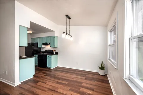 a kitchen with kitchen island a counter top space a sink and appliances