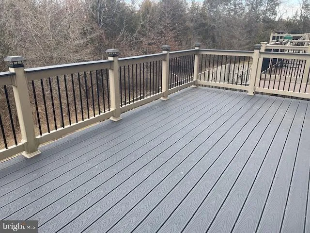 a view of deck with wooden floor and fence