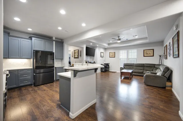 a kitchen with granite countertop a refrigerator and a sink