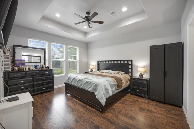 a bathroom with a double vanity sink a large mirror a shower and bathtub