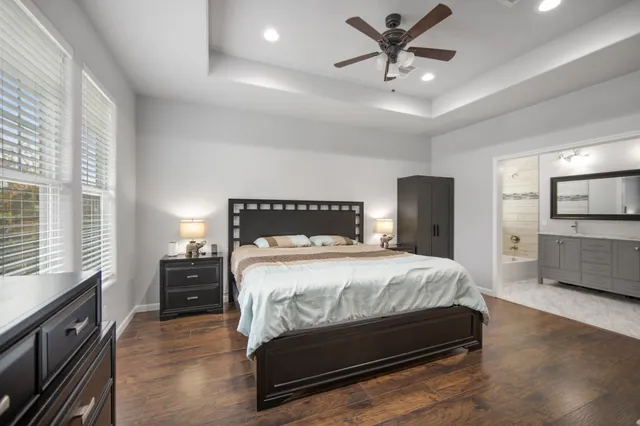 a bathroom with a granite countertop sink a toilet and a mirror