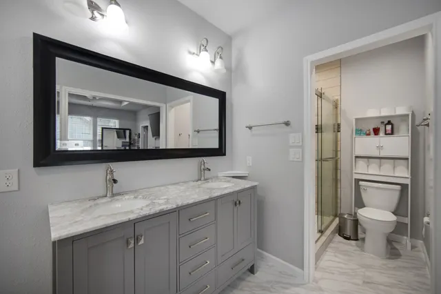 a bathroom with a sink a toilet and mirror