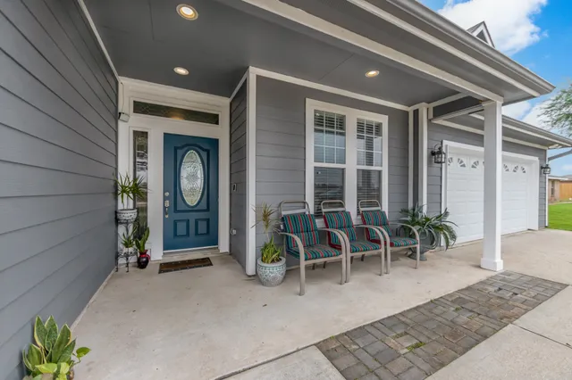 a front view of a house with a garden and deck