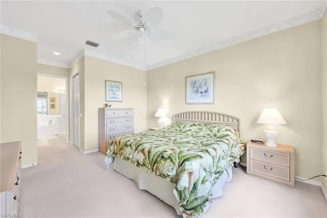 a bedroom with a bed and a dresser with mirror