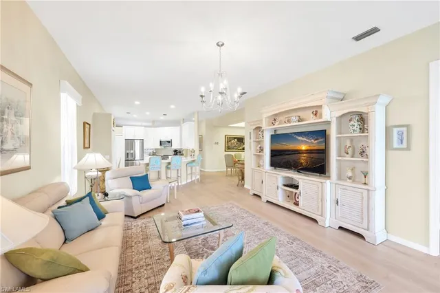 a living room with furniture and a chandelier
