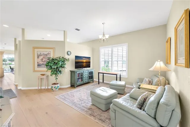 a living room with furniture a large window and a flat screen tv