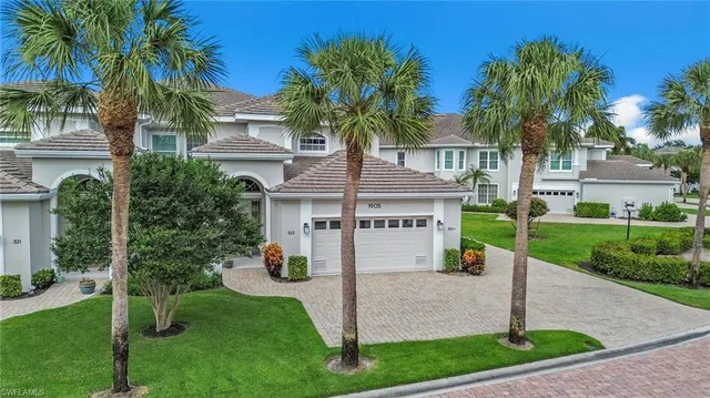 a front view of a house with garden and plants